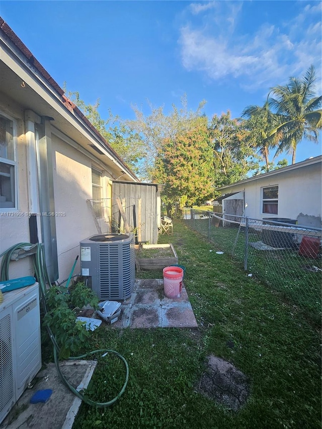 view of yard with central AC unit and ac unit