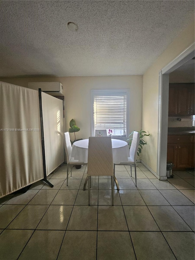 unfurnished dining area with a wall mounted AC, a textured ceiling, and light tile patterned floors