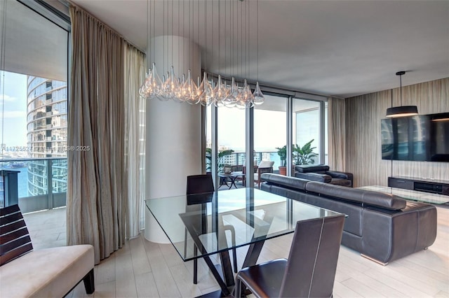 dining space featuring floor to ceiling windows and light wood-type flooring