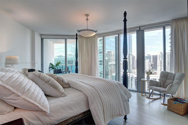 bedroom featuring multiple windows, access to outside, and expansive windows