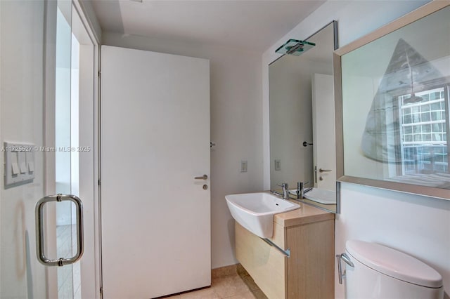 bathroom with vanity, tile patterned flooring, and toilet