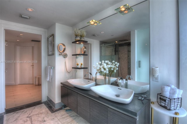 bathroom with walk in shower and vanity