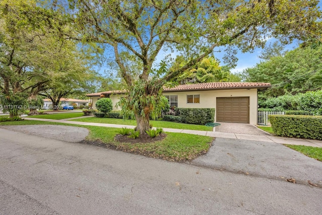 view of front of home featuring a garage and a front lawn