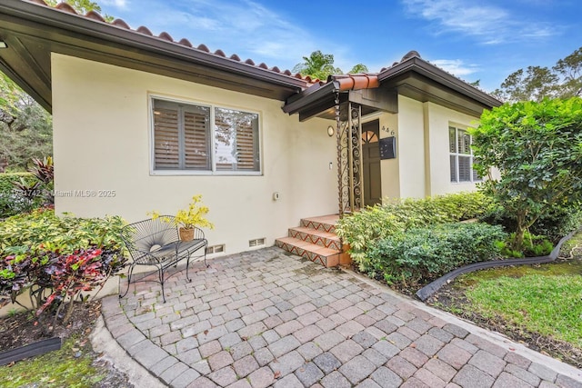 entrance to property with a patio