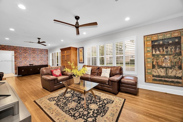 living room featuring ornamental molding, ceiling fan, and light hardwood / wood-style floors