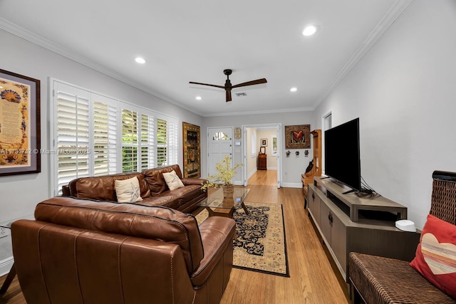 living room featuring ornamental molding, ceiling fan, and light hardwood / wood-style flooring