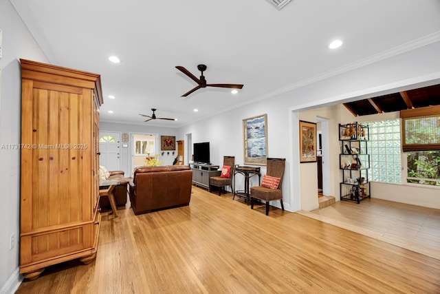 living room featuring ceiling fan, ornamental molding, and light hardwood / wood-style floors