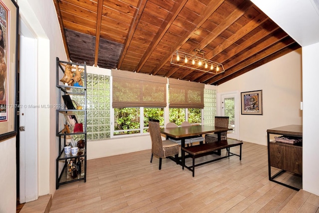 dining room with vaulted ceiling with beams, wood ceiling, plenty of natural light, and light wood-type flooring