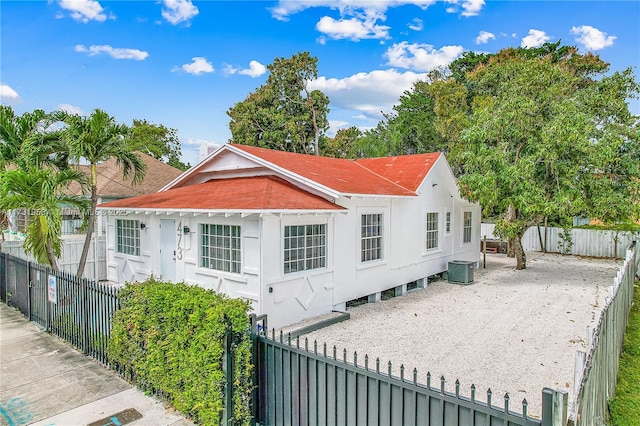 rear view of property with central AC