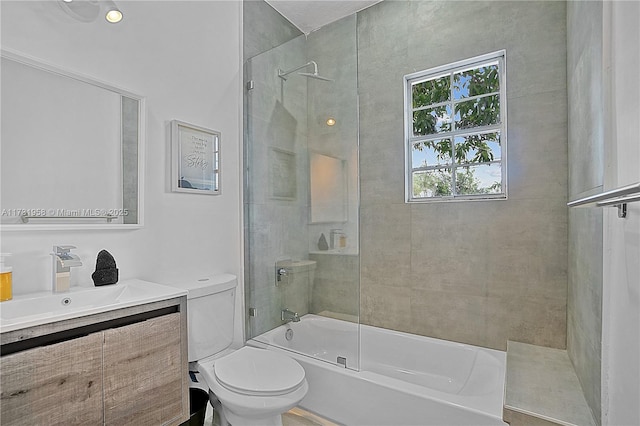 full bathroom featuring vanity, enclosed tub / shower combo, and toilet