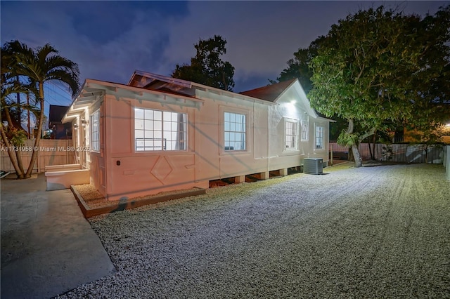 property exterior at dusk featuring central air condition unit