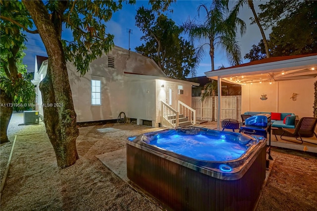 exterior space with cooling unit and a hot tub