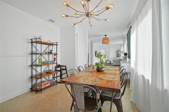 dining area with a notable chandelier