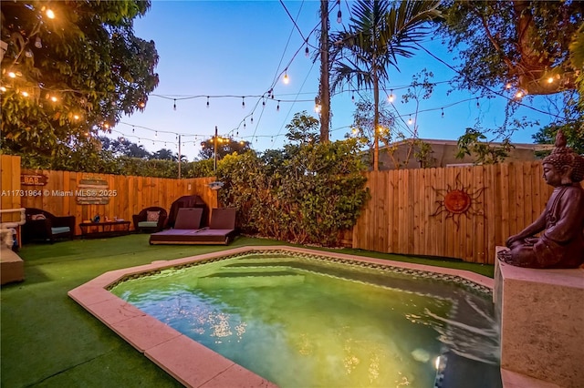 view of swimming pool featuring a lawn