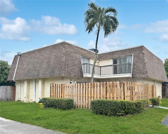 8212 SW 23rd Ct Unit 18D, North Lauderdale, FL 33068 - back of property with brick siding, mansard roof, a balcony, and roof with shingles