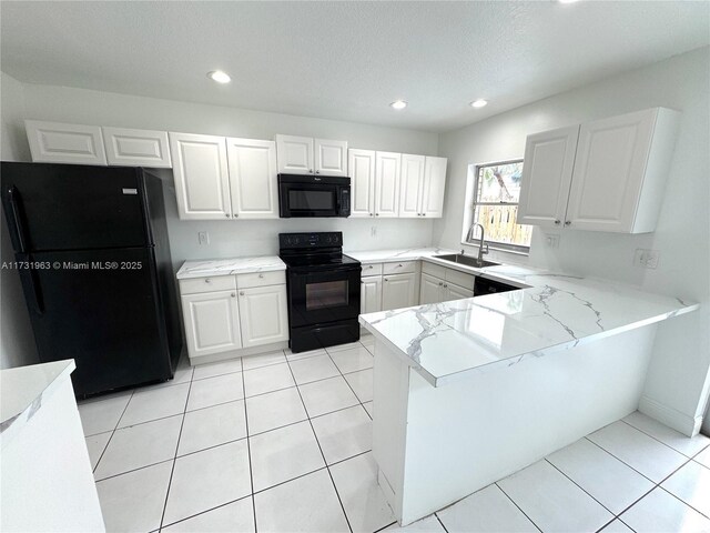 8212 SW 23rd Ct Unit 18D, North Lauderdale, FL 33068 - kitchen featuring black appliances, a sink, white cabinets, recessed lighting, and a peninsula