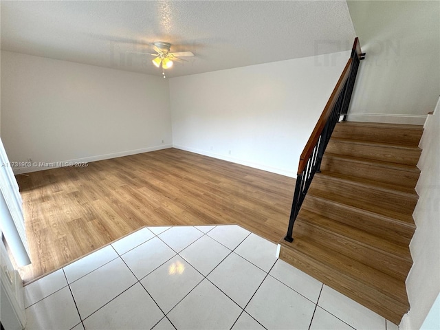 interior space with ceiling fan and a textured ceiling