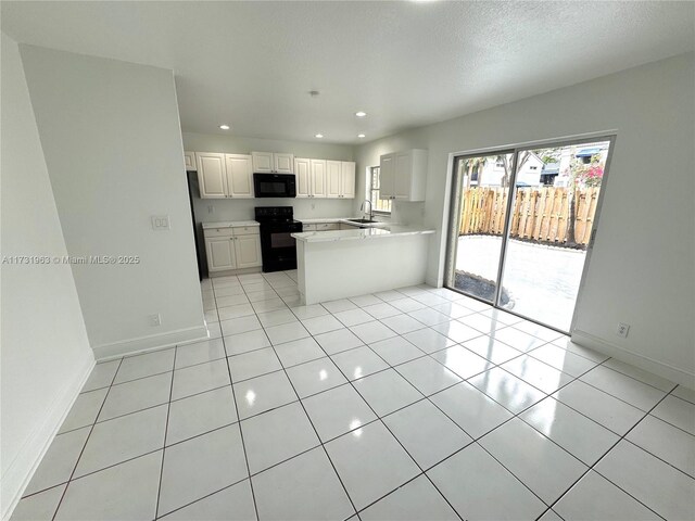 8212 SW 23rd Ct Unit 18D, North Lauderdale, FL 33068 - kitchen featuring black appliances, baseboards, recessed lighting, a sink, and light countertops
