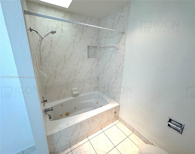 bathroom with tiled shower / bath and tile patterned flooring