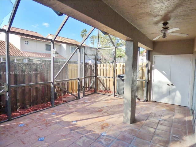 view of patio / terrace featuring a lanai and ceiling fan