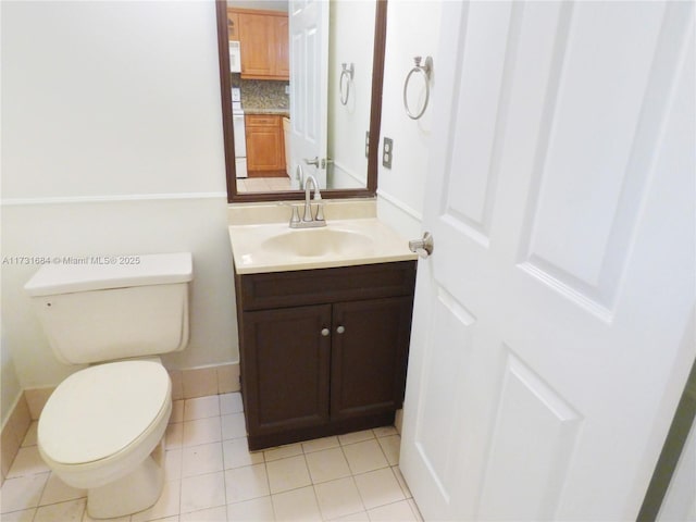 bathroom with vanity, backsplash, tile patterned floors, and toilet