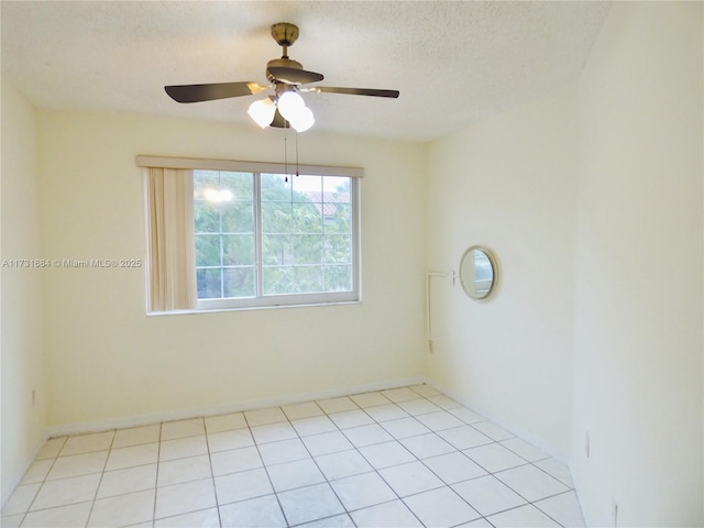 unfurnished room featuring ceiling fan, a textured ceiling, and light tile patterned floors