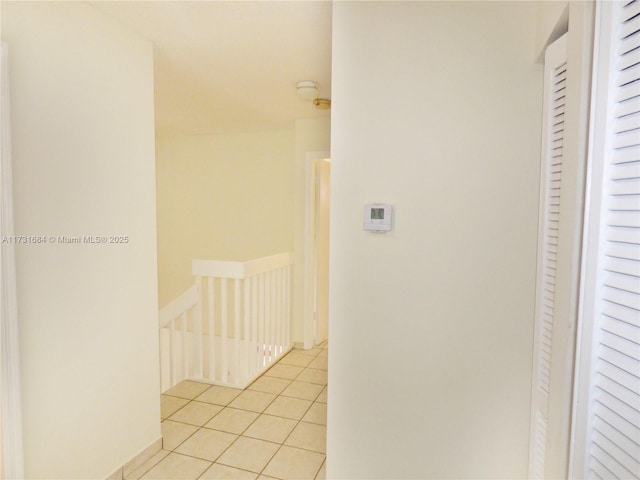 hall with light tile patterned floors