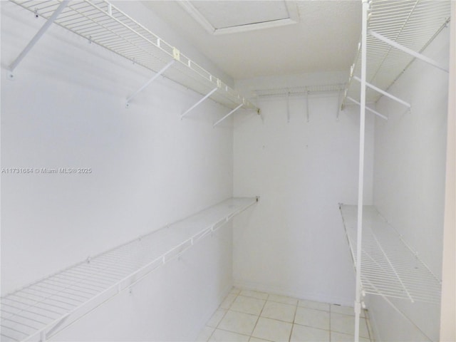 spacious closet featuring light tile patterned flooring