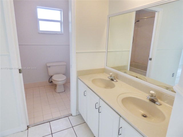 bathroom with tile patterned flooring, vanity, a shower, and toilet