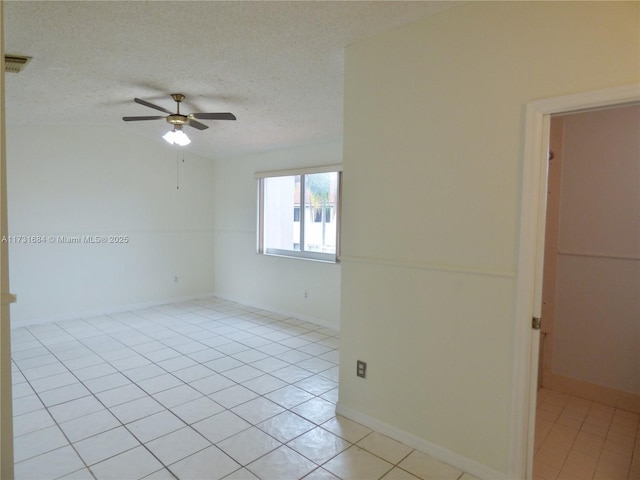 unfurnished room with ceiling fan, a textured ceiling, and light tile patterned floors