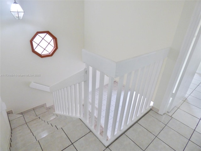 stairs featuring tile patterned flooring