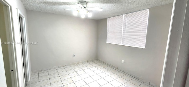 spare room with a textured ceiling and ceiling fan