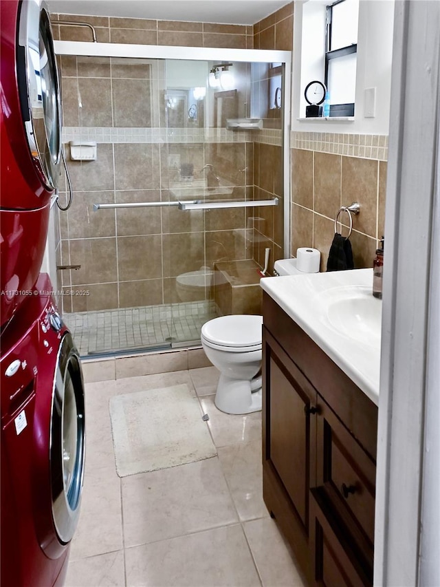 bathroom featuring vanity, toilet, an enclosed shower, and tile walls