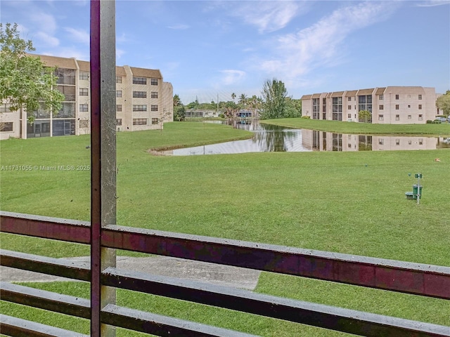 view of home's community featuring a yard and a water view