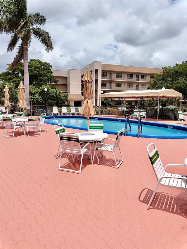 view of swimming pool featuring a patio area