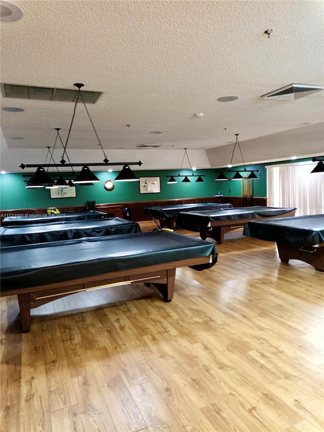 playroom featuring hardwood / wood-style floors, a textured ceiling, and billiards