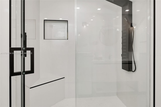 bathroom featuring a shower with shower door