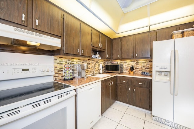 kitchen with tasteful backsplash, sink, white appliances, and light tile patterned flooring