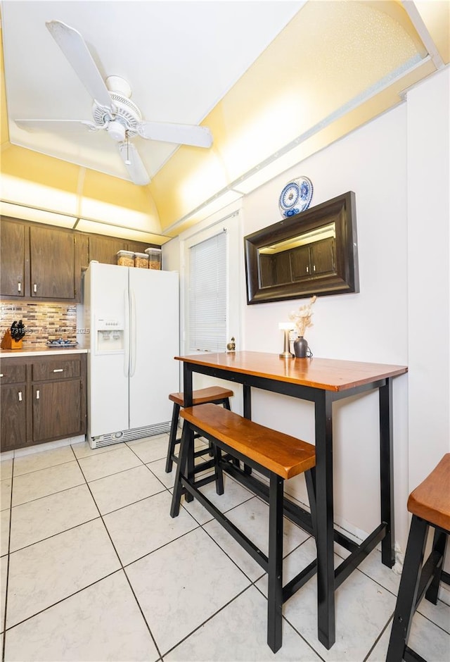 tiled dining room featuring ceiling fan and lofted ceiling