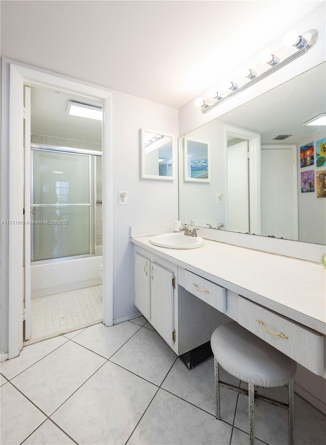 bathroom with vanity, tile patterned floors, and shower / bath combination with glass door