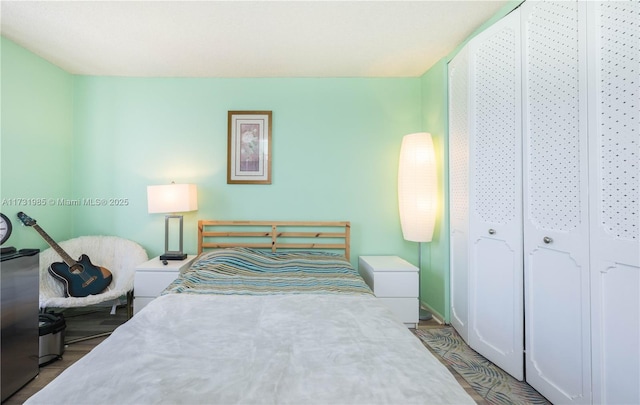 bedroom featuring a closet and light hardwood / wood-style flooring