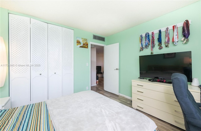 bedroom featuring hardwood / wood-style flooring and a closet