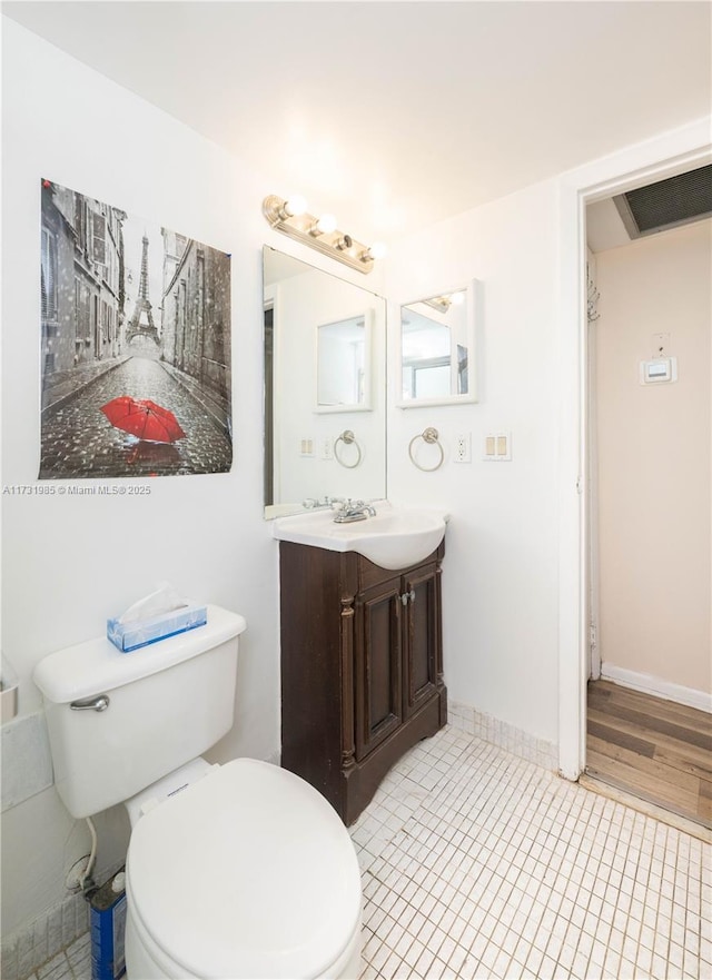 bathroom featuring vanity, toilet, and tile patterned flooring