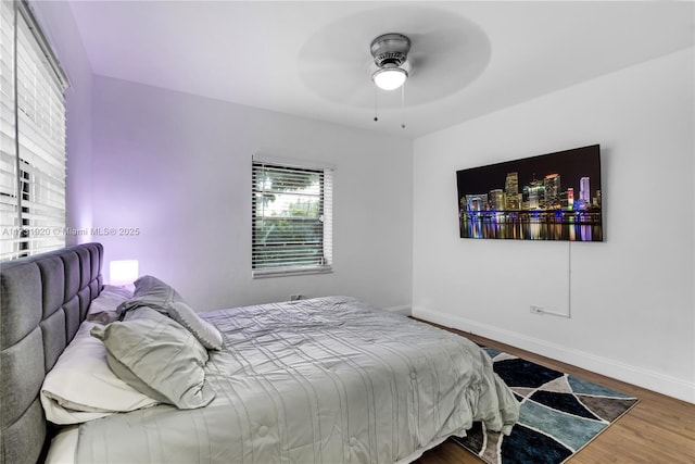 bedroom featuring hardwood / wood-style flooring and ceiling fan