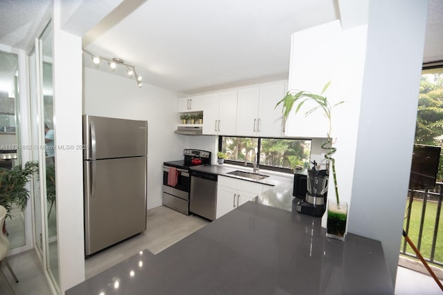 kitchen featuring white cabinetry, sink, light hardwood / wood-style floors, and appliances with stainless steel finishes