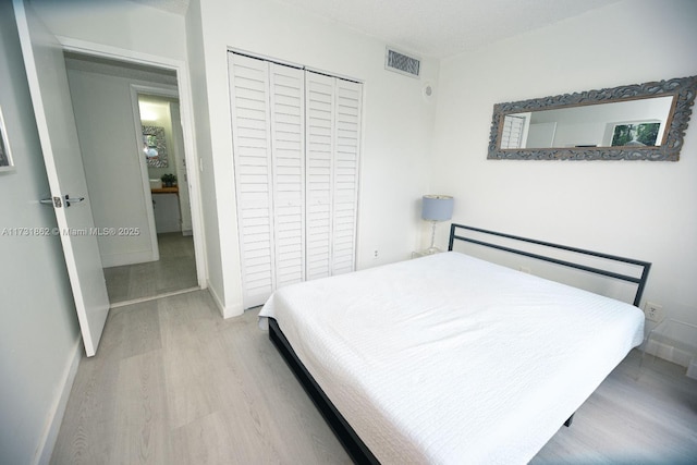 bedroom featuring light hardwood / wood-style floors and a closet