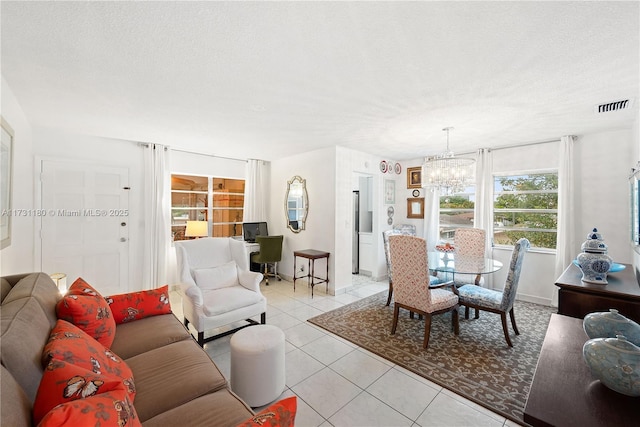 tiled living room with a chandelier and a textured ceiling