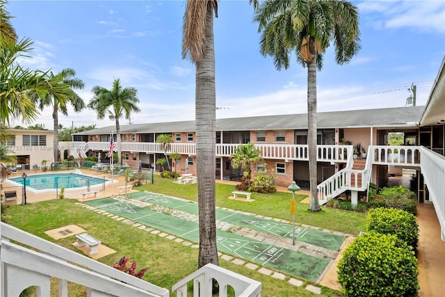 view of swimming pool with a lawn