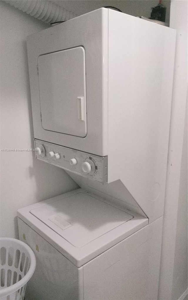 laundry area featuring stacked washer / dryer