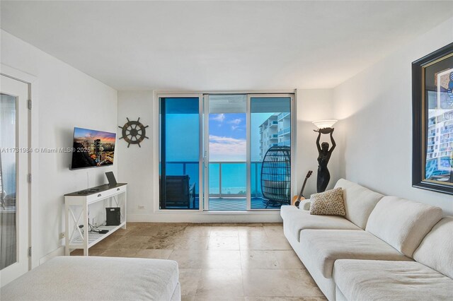 balcony with a water view and a view of the beach